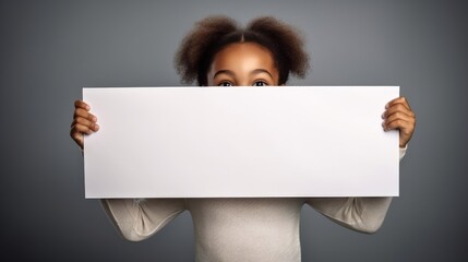 little girl holding white blank paper