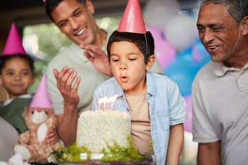 Boy, birthday party and blow candles with cake, celebration and support with applause, hat and...