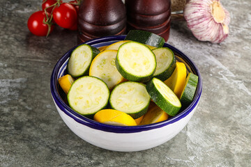 Sliced raw young green and yellow zucchini