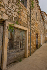 Fototapeta na wymiar A street of historic stone houses in Milna Village on the west coast of Brac Island in Croatia