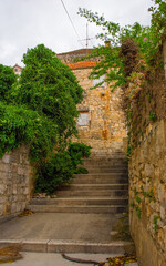 Fototapeta premium A street of historic stone houses in Milna Village on the west coast of Brac Island in Croatia