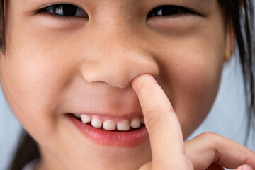 Headshot cropped image of cute preschool girl making funny silly face.