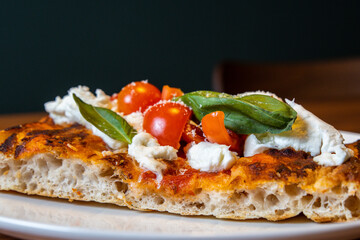 Focaccia is a typical Italian appetizer or snack, which is refined with vegetables, cheese, mortadella, basil or simple spreads and olive oil