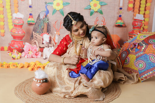  krishna Janmashtami Concept. Mother sitting with her cute baby boy celebrating traditional festival of india 
