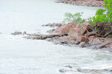 beach front with rocks by the sea.