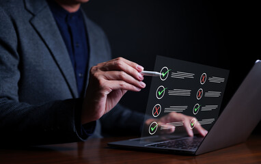 Businessman evaluating with checkboxes on online laptop computer. assessment survey online, choose...