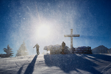 cross in the snow, with skier