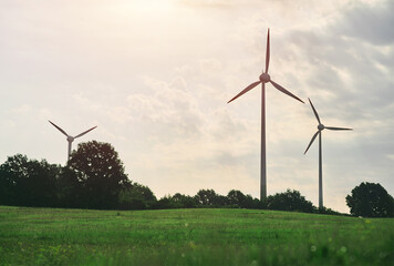 Wind turbines in a wind farm in a beautiful natural environment on a sunny summer day. Renewable...