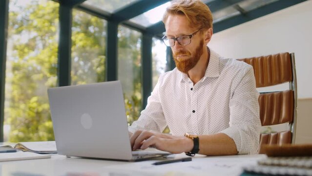 Skilled design expert using laptop to sketch new furniture