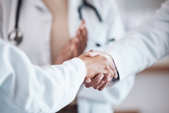 Closeup, teamwork or doctors shaking hands for goal, good job or promotion success in a hospital meeting. Clapping, congratulations or proud healthcare worker with handshake for medical collaboration
