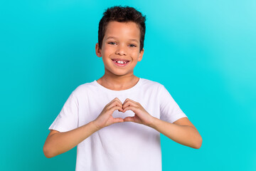 Portrait of grateful kind boy wear stylish white clothes fingers demonstrate heart shape isolated...
