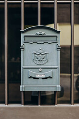 Typical vintage Italian mailboxes in grey, on a white wall