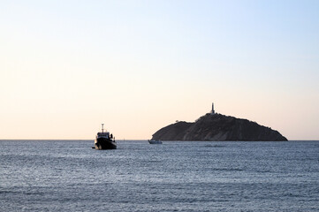 Santa Marta, Colombia - December 30 2022: fishing boat at sunset in el morro islan