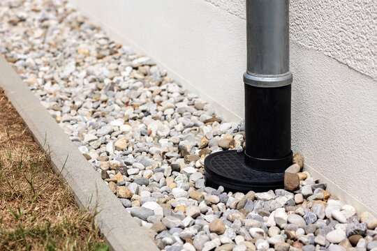 French Drain Building Wall. Drain Pipe going into Drainage  Floor with Gravel Stones aroud House. Drainage Foundation