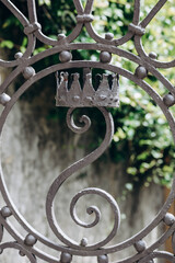 Wrought iron fence lattice with the image of the crown