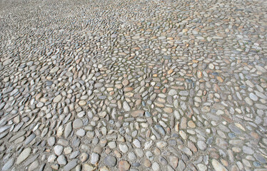 Rustic old natural stone paving, detail.