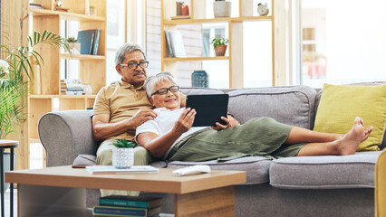 Relax, senior couple and a tablet for a movie, reading information or streaming a film on the sofa....