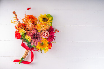Autumn holidays greeting card background. Autumn red, orange, bright flowers and leaves a big bouquet on white gold background. Teacher's Day, Thanksgiving Day, Halloween background