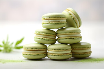 Matcha macaroons on a light baclground with copy space for text. Matcha green tea macarons with vanilla cream, matcha dessert. Creamy pistachio macarons background