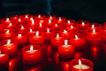 Close-up of red candles in the cathedral of the city of Como in Italy