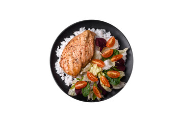 Delicious healthy breakfast consisting of chicken, rice, greens and cherry tomatoes