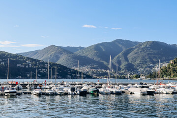 Fototapeta na wymiar Como, Italy - August 8, 2023: Port near the town of Como in Italy on the lake of the same name