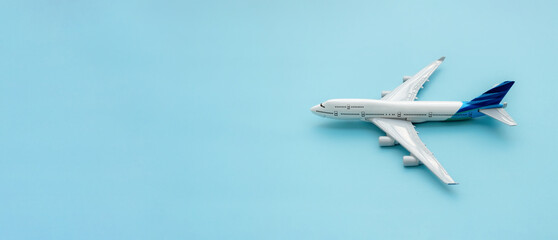 A plane miniature isolated on blue background, after some edits.