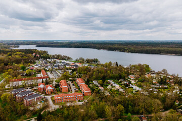 weitläufige Landschaft mit einem See, einem Wald und einer bewohnten Gegend