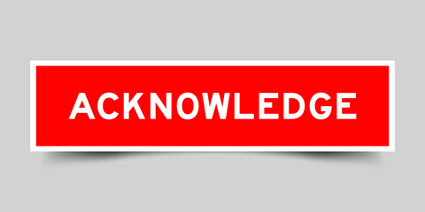 Sticker label with word acknowledge in red color on gray background