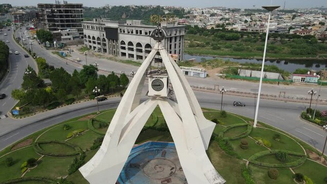 Capturing the Magnificent Clock Tower of Bahria Town Phase 7, Rawalpindi: Aerial Elegance Unveiled in Every Frame. Explore the Beauty of this Landmark from New Heights.