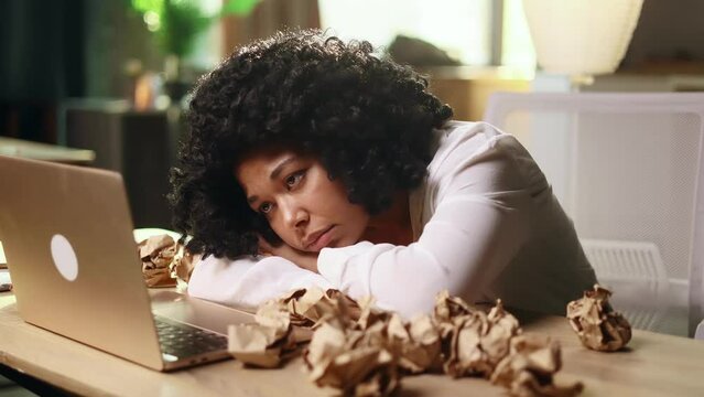 Portrait of exhausted young woman with failed ideas while take a break at home Tired female with creative block or lack of inspiration indoors