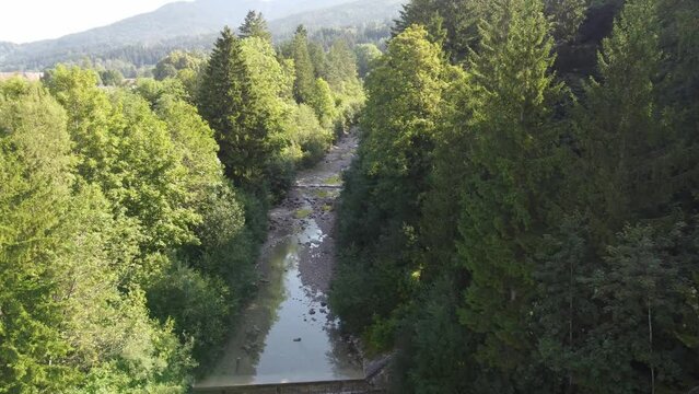 Stream in Upper Bavaria with small barrages and surrounded by deciduous trees, 4k