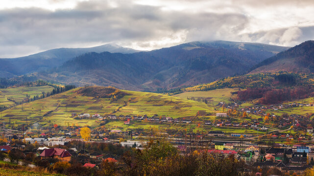 rural landscape in mountains. remote village in the valley. countryside scenery in autumn. overcast weather