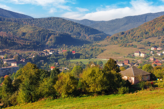 rural landscape in mountains. remote village in the valley. countryside scenery in autumn. sunny morning