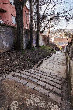 european downtown street with steps down the hill. early spring weather. travel and sightseeing concept