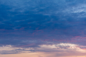 Pink blue clouds at sunset as background