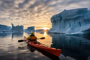 Tuinposter lonely journey to island of ice winter kayaking in antarctica. sports, cold and glaciers in the ocean © Svetlana