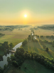 Mglisty poranek nad rzeką o wschodzie słońca  