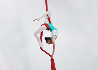 Aerial, woman gymnast fitness and sport performance with girl flexibility and athlete with white...