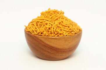 Close up of Spicy Aloo Bhujia In hand-made (handcrafted) wooden bowl, made with Red chili, Potatoes, and Chickpeas. Indian spicy snacks (Namkeen),