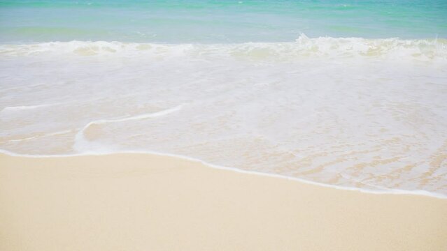 Beautiful white sand clean beach. Waves texture Lapping across untouched Shore.