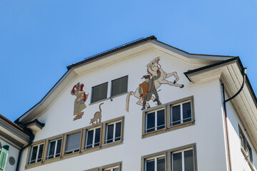 Fototapeta na wymiar Lucerne, Switzerland - August 10, 2023: Beautiful painted facades in the downtown Lucerne in Switzerland on a sunny summer day