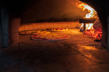 A delicious pizza with cheese, sausage, and vegetables bakes over the fire, taking only 5 minutes in a home oven