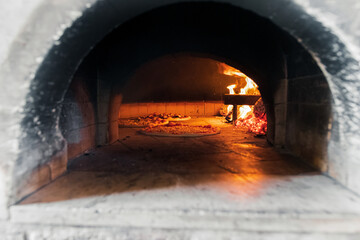 A delicious pizza with cheese, sausage, and vegetables bakes over the fire, taking only 5 minutes in a home oven