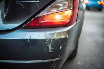 Deurstickers Dented Rear Bumper of Car After Parking Lot Accident - Damage to Vehicle Auto With Rear Damage © AIGen