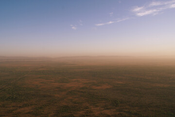 Aerial view of the Australian outback with the West MacDonnell Ranges in the morning mist, Red Centre, Northern Territory, Australia