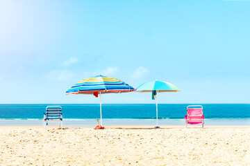 Quiet beach with umbrellas and chairs. Selective focus