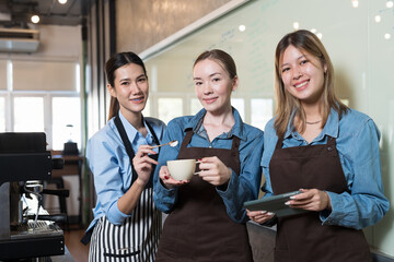 Group of young women barista working and preparing coffee for customer in coffee shop. Coffee owner concept. Small business and start up business