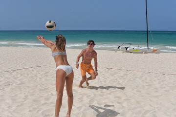 Volleyball player setting the ball in coed beach game