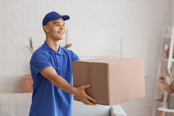 Young courier with parcel in room